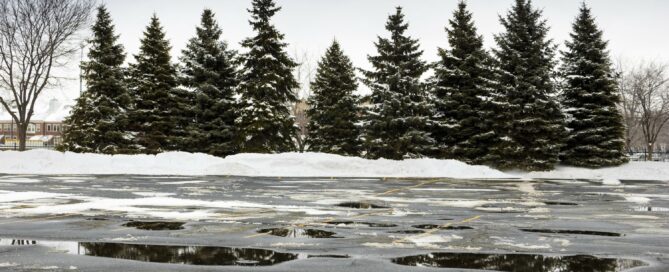 Image of wet parking lot with snow representing the need for concrete contracting in Kansas City with Mega KC