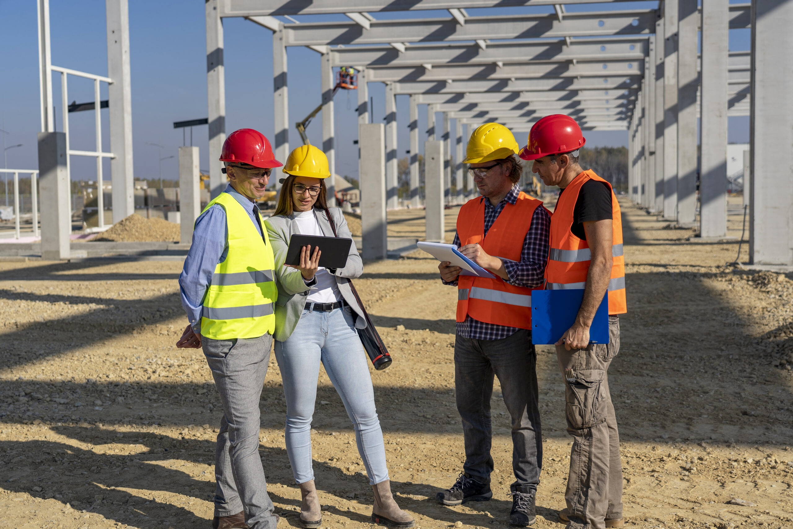 Construction-Project-Manager-And-His-Team-Discuss-A-Project-On-Construction-Site