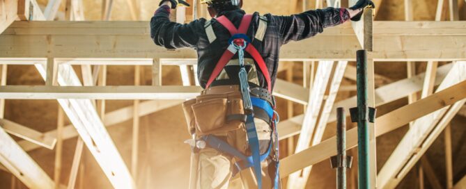 A construction worker framing a house