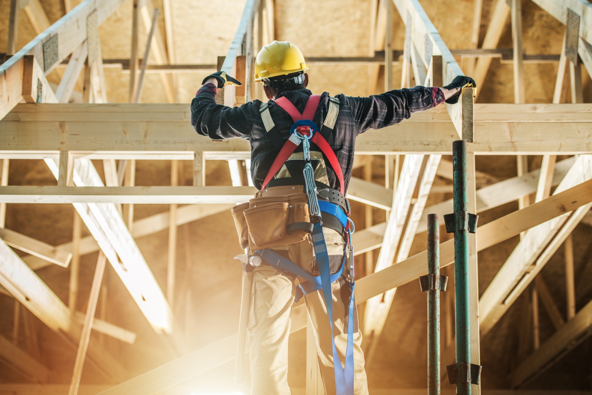 A construction worker framing a house